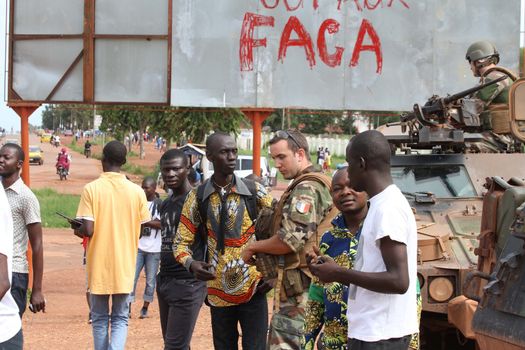 CENTRAL AFRICAN REPUBLIC, One French soldier talks to locals in Bangui, as the Sangaris armed force patrols in the city, on October 2, 2015. The Central African Republic descended into bloodshed more than two years ago after long time president Francois Bozize, a Christian, was ousted by Seleka rebels, triggering the worst crisis since independence in 1960. On September 29, 2015, Bangui returned to only relative calm after three days of inter-community violence which left at least 40 dead and 100 injured according to the UN Refugee Agency UNHCR. Some 27,000 inhabitants of Bangui have also fled to displaced people's camps.
