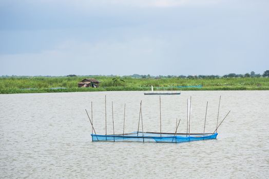 Feeding stations at a fish farm at the Ayeyarwaddy Region in Myanmar. Shallow depth of field with the nearest feeding station in focus.