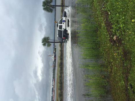 UNITED-STATES, Charleston : Wheel rims of a running police car are under water when catastrophic floods ravaged much of South Carolina on October 4, 2015. Heavy rains dropped nearly 17 inches on the state capital of Charleston in a 17 hour span. At least nine people died in South Carolina as a result of the flooding and one person has died in neighboring North Carolina. The storms also left some 30,000 residents without power and shut down many major roads. Governor Nikki Haley called the rains the worst in 1,000 years. 