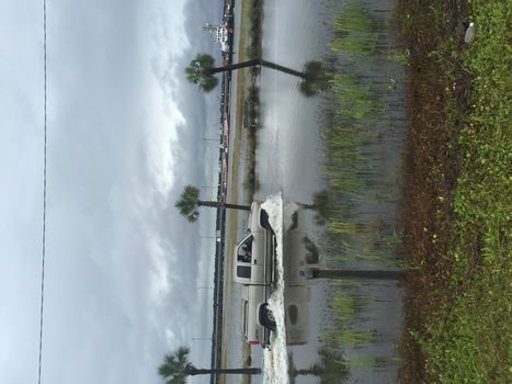 UNITED-STATES, Charleston : Wheel rims of a running car are under water when catastrophic floods ravaged much of South Carolina on October 4, 2015. Heavy rains dropped nearly 17 inches on the state capital of Charleston in a 17 hour span. At least nine people died in South Carolina as a result of the flooding and one person has died in neighboring North Carolina. The storms also left some 30,000 residents without power and shut down many major roads. Governor Nikki Haley called the rains the worst in 1,000 years. 