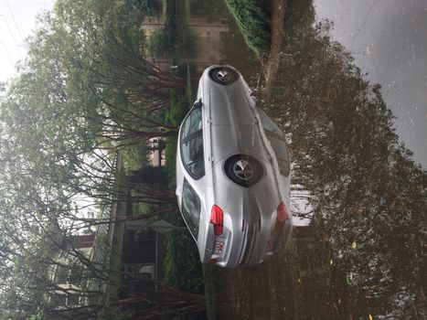 UNITED-STATES, Charleston : Wheel rims of a running car are under water when catastrophic floods ravaged much of South Carolina on October 4, 2015. Heavy rains dropped nearly 17 inches on the state capital of Charleston in a 17 hour span. At least nine people died in South Carolina as a result of the flooding and one person has died in neighboring North Carolina. The storms also left some 30,000 residents without power and shut down many major roads. Governor Nikki Haley called the rains the worst in 1,000 years. 