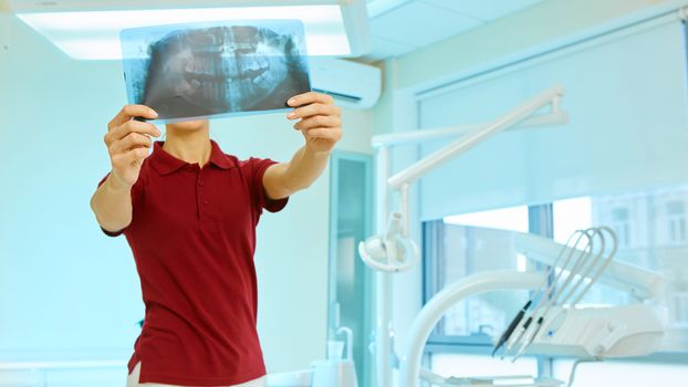 picture of female doctor or dentist looking at x-ray