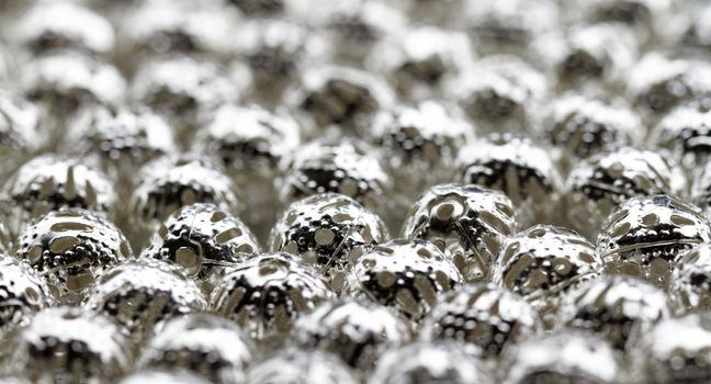 Beautiful metal beads closeup on white background