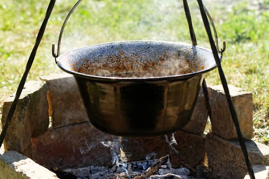 Photo of the tasty goulash in cauldron