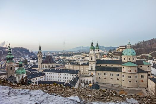 Salzburg, Austria - December 31, 2013: View from Fortress Hohensalzburg to the Kapitelplatz square with Dome of Salzburg, St. Peter abbey church - after sunset