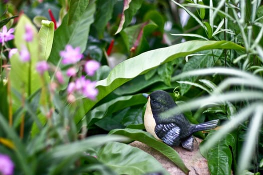 Bird statue with garden background