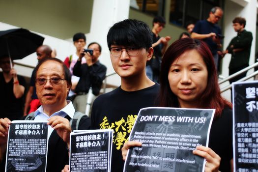 CHINA, Hong-Kong : Three students held signs saying Don't mess with us when around 1 000 students, professors and academics dressed in black protest with a silent march in the University of Hong Kong  campus against alleged Pekin interference in an academic nomination on October 6th, 2015. The university council rejected by an unclear vote the nomination of law dean Johannes Chan Man-num as pro-vice-chancellor. Johannes Chan Man-num is known to be close to a Hong-Kong Occupy movement leader. 