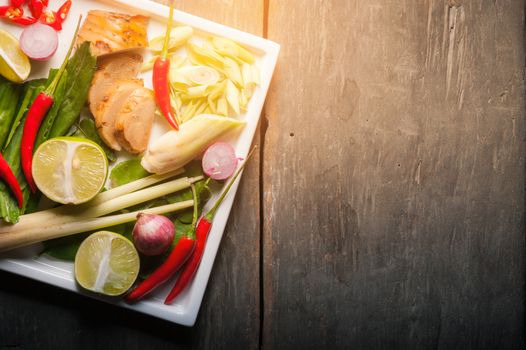 Ingredients for Thai spicy soup (Tom-yum) on wood table with morning low key scene