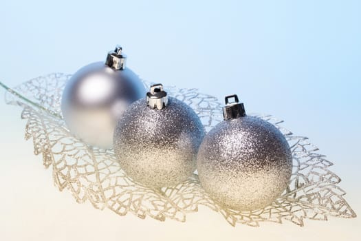 New Year background with three silver glass toys