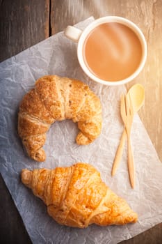 Butter croissant and whole wheat croissant on wood table with morning scene