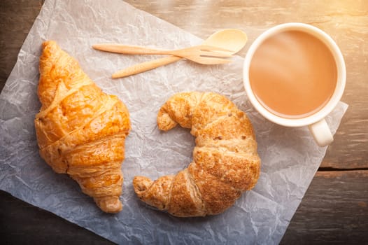 Butter croissant and whole wheat croissant on wood table with morning scene
