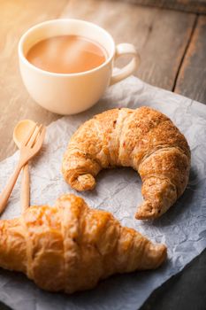 Butter croissant and whole wheat croissant on wood table with morning scene