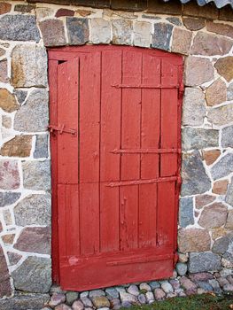 Old vintage decorated wooden brown door as an entry to a city house