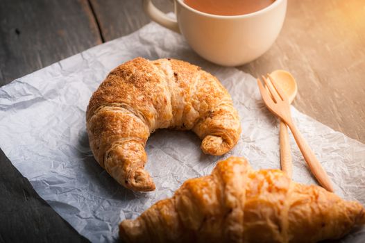 Butter croissant and whole wheat croissant on wood table with morning scene