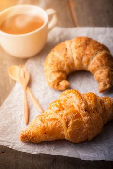 Butter croissant and whole wheat croissant on wood table with morning scene