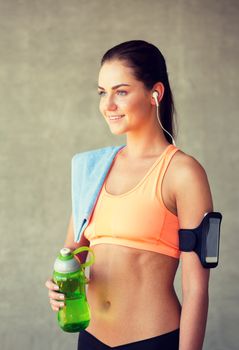 fitness, sport, training, drink and lifestyle concept - woman with bottle of water in gym