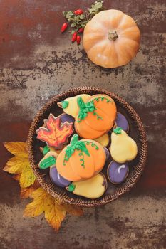 Thanksgiving cookies in the shape of pumpkin, pear, plum and leaves. Fall decorated cookies