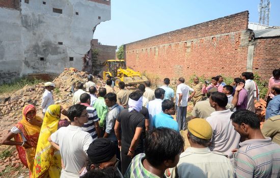 INDIA, Allahabad: People gather near the debris of two houses which collapsed on October 6, 2015, after an explosion at a firecracker factory. According to our contributor on the ground, the firecracker factory was operating illegally.