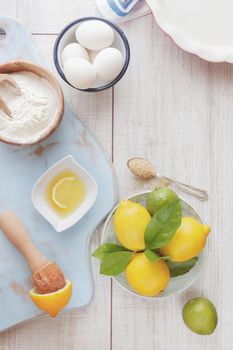 Ingredients for lemon icebox pie on wooden table, vintage style, top view. Natural light