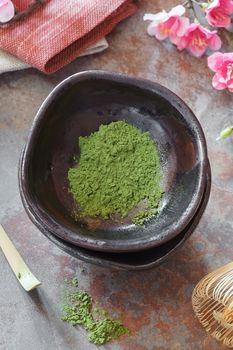 Still life with matcha green tea and bamboo whisk. Japanese Tea Ceremony: Preparation of powdered green tea.Macro, selective focus. Natural light