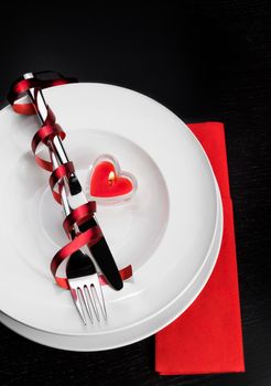 restaurant series. Valentine day dinner with table setting in red and holiday elegant heart ornaments