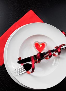 restaurant series. top of view of Valentine day dinner with table setting in red and holiday elegant heart ornaments