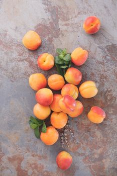 Still life of fresh apricots on a rustic stone surface, top view, rustic style. Natural light