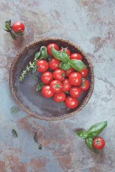 Cherry tomatoes. Tomatoes in a wooden bowl on rustic table. Overhead view with retro style processing. Natural light