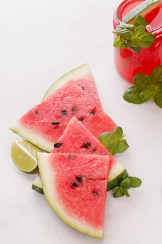 Watermelon slices and watermelon fruit drink on table. Macro, selective focus, natural light