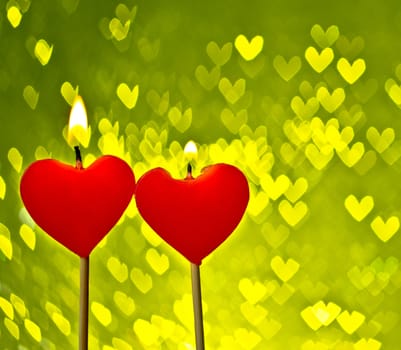 red hearts candles on yellow hearts bokeh as background, valentine day and love concept