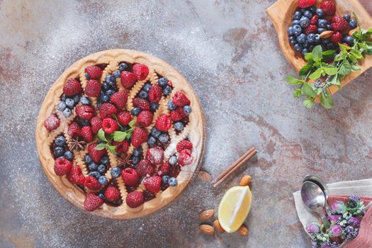 Fresh summer raspberry blueberry tart with a shortbread crust, top view