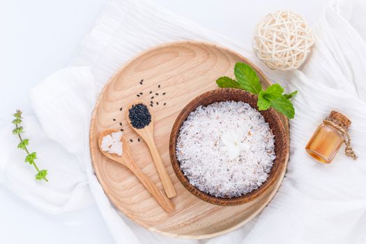 Raw coconut and coconut essential oils  with sea salt and herbs natural spa Ingredients for scrub and skin care isolate on white background.
