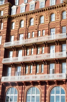 Balconies of large red brick victorian hotel