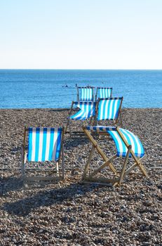 Deckchairs on shingle beach