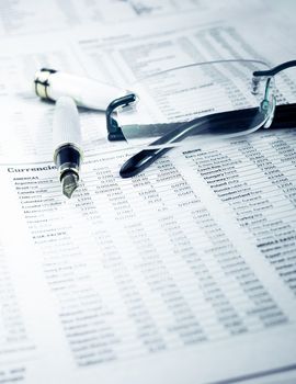 pen and glasses on financial chart, business concept