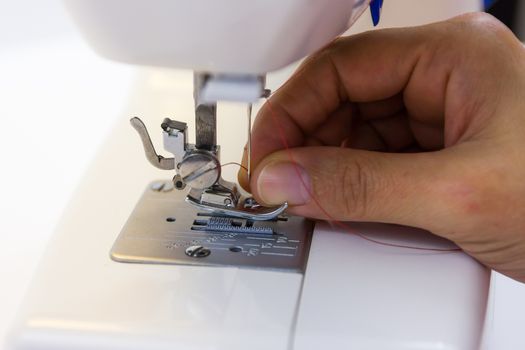 seamstress while working with the sewing machine