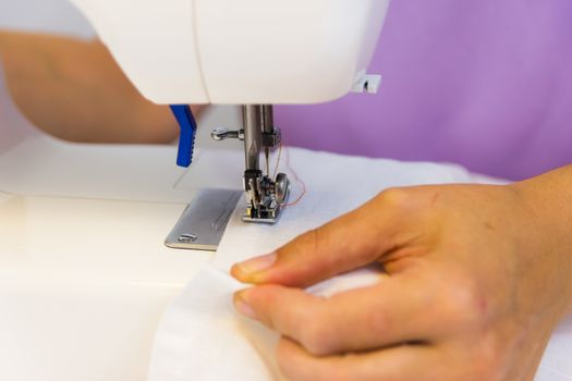 seamstress while working with the sewing machine