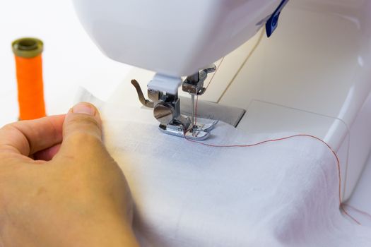 seamstress while working with the sewing machine