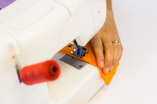 seamstress while working with the sewing machine