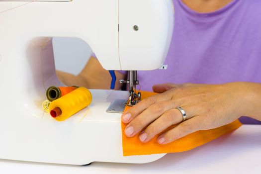 seamstress while working with the sewing machine