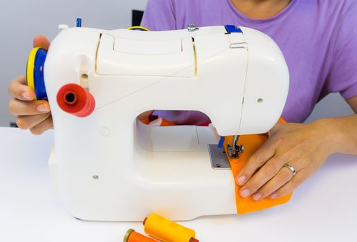 seamstress while working with the sewing machine