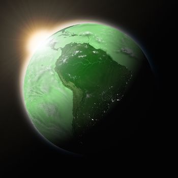 Sun over South America on green planet Earth isolated on black background. Highly detailed planet surface. Elements of this image furnished by NASA.