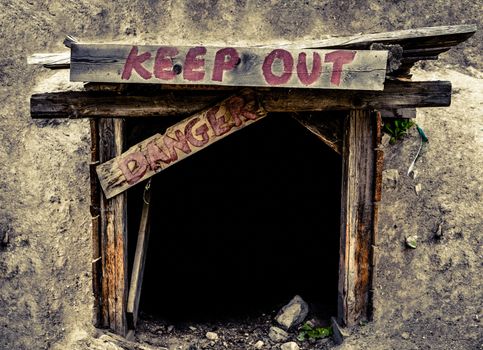 Conceptual Image Of A An Entrance To An Old Mine Tunnel With Keep Out And Danger Signs