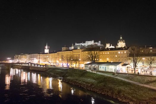Salzburg, Austria - June 25, 2014: Hohensalzburg Fortress in Salzburg, Austria, view from the Salzach river by night.