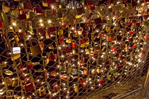 Salzburg, Austria - December 31, 2013: Love Padlocks at Markatsteg bridge in Salzburg by night. The thousand of locks of loving couples symbolizing love forever.