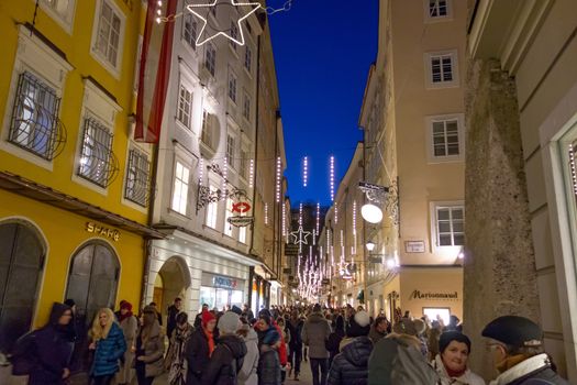 Salzburg, Austria - December 31, 2013: Street Getreidegasse, at the birth house of Wolfgang Amadeus Mozart by night on New Year's Eve