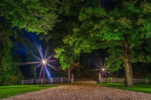 Driveway lights beckon the weary road traveler at day's end.