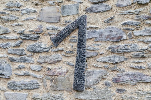 Old castle stone wall with speed Nr. 1 in wrought iron. texture background