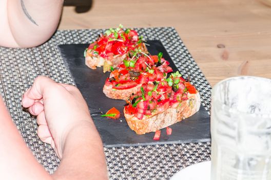Bruschetta with tomatoes, mozzarella and chives.