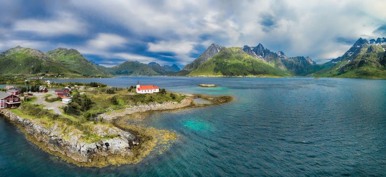 Scenic aerial panorama of fjord with Sildpollnes Church on Lofoten islands in Norway
